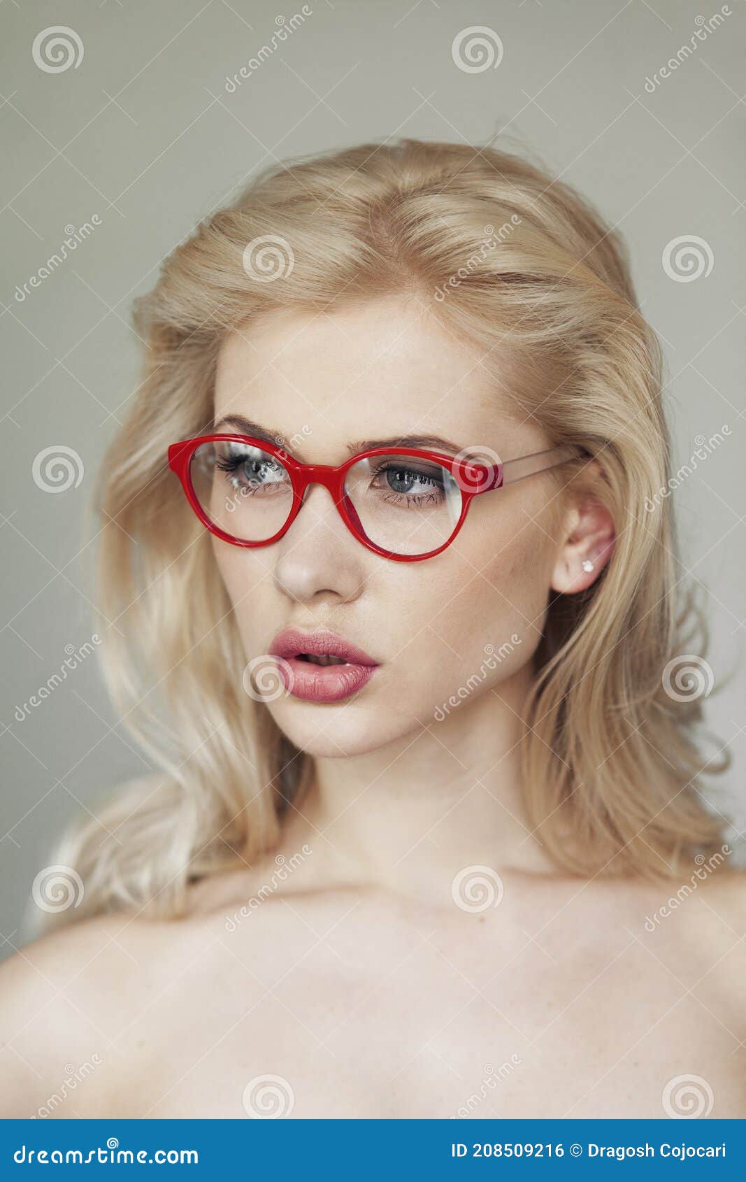 Closeup Portrait Of A Blonde Woman With Makeup Wearing Red Eyeglasses