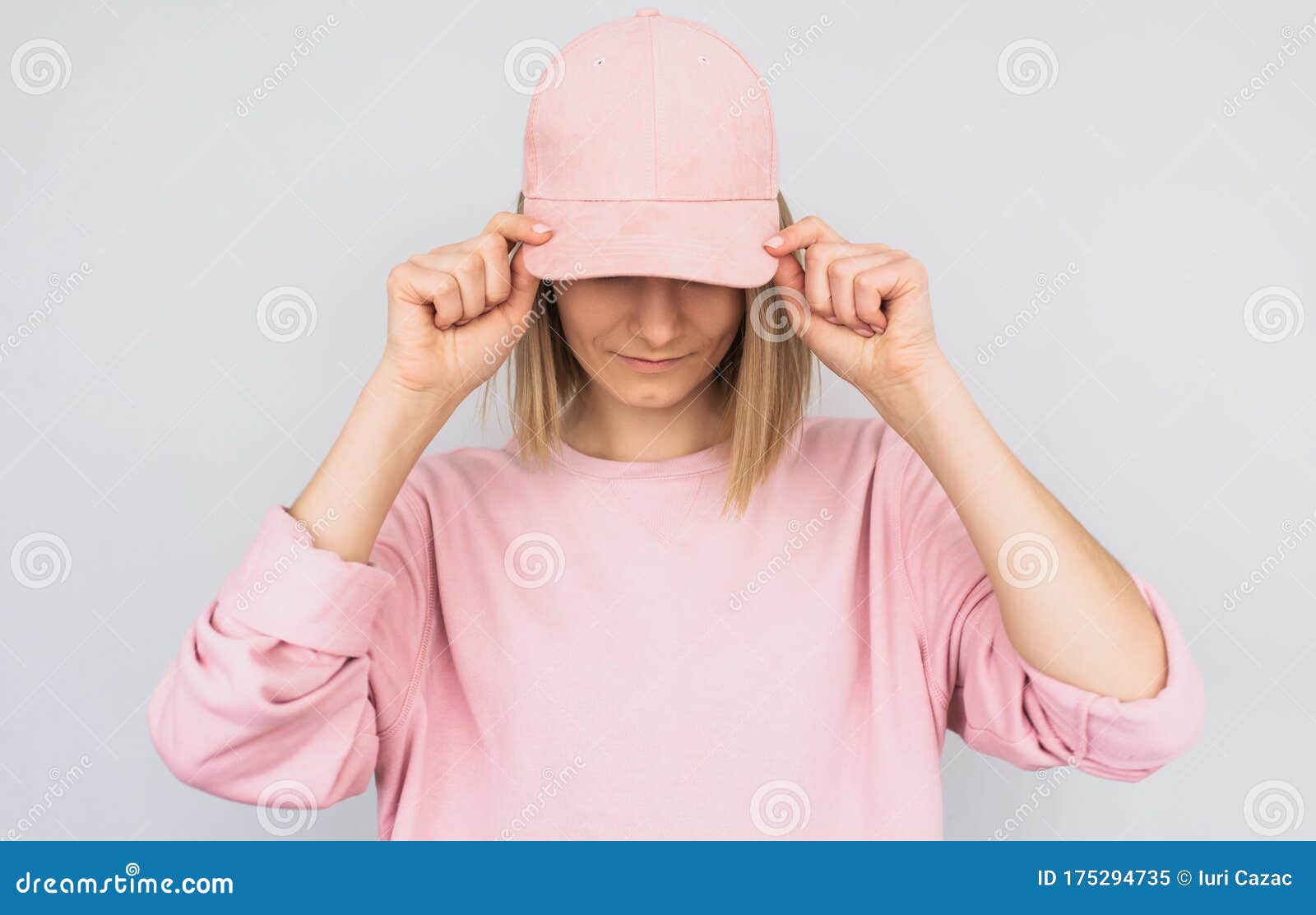 cap wearing blonde pink