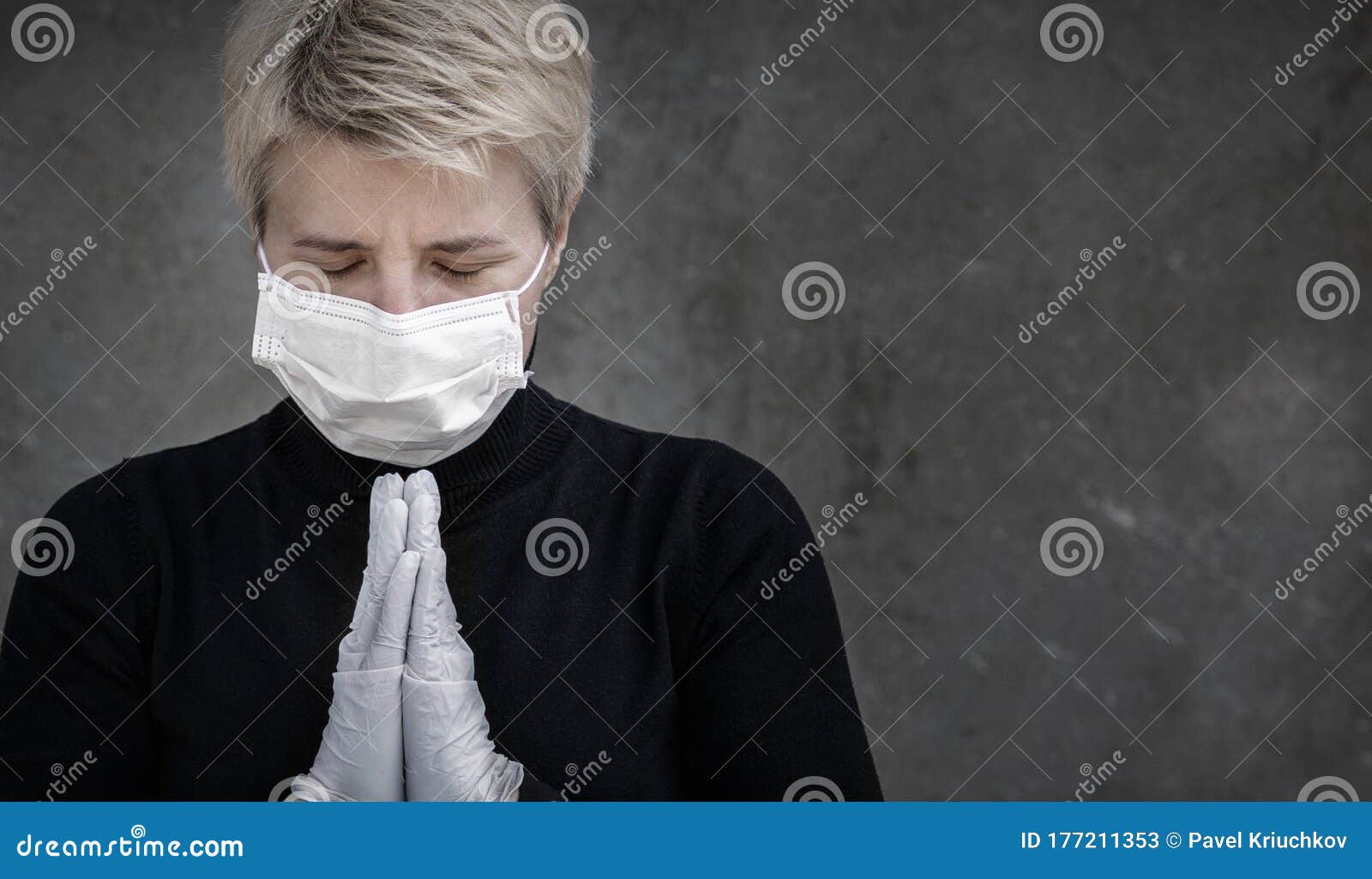 closeup portrait of a sad woman in medical mask outdoors. prayer