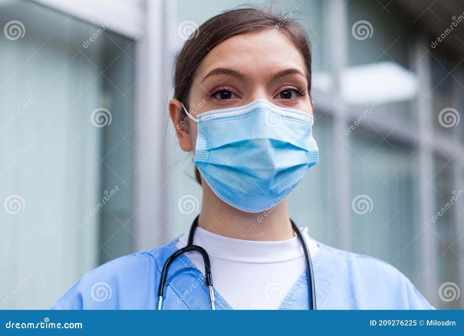 closeup portrait of very tired exhausted uk nhs icu doctor in front of hospital