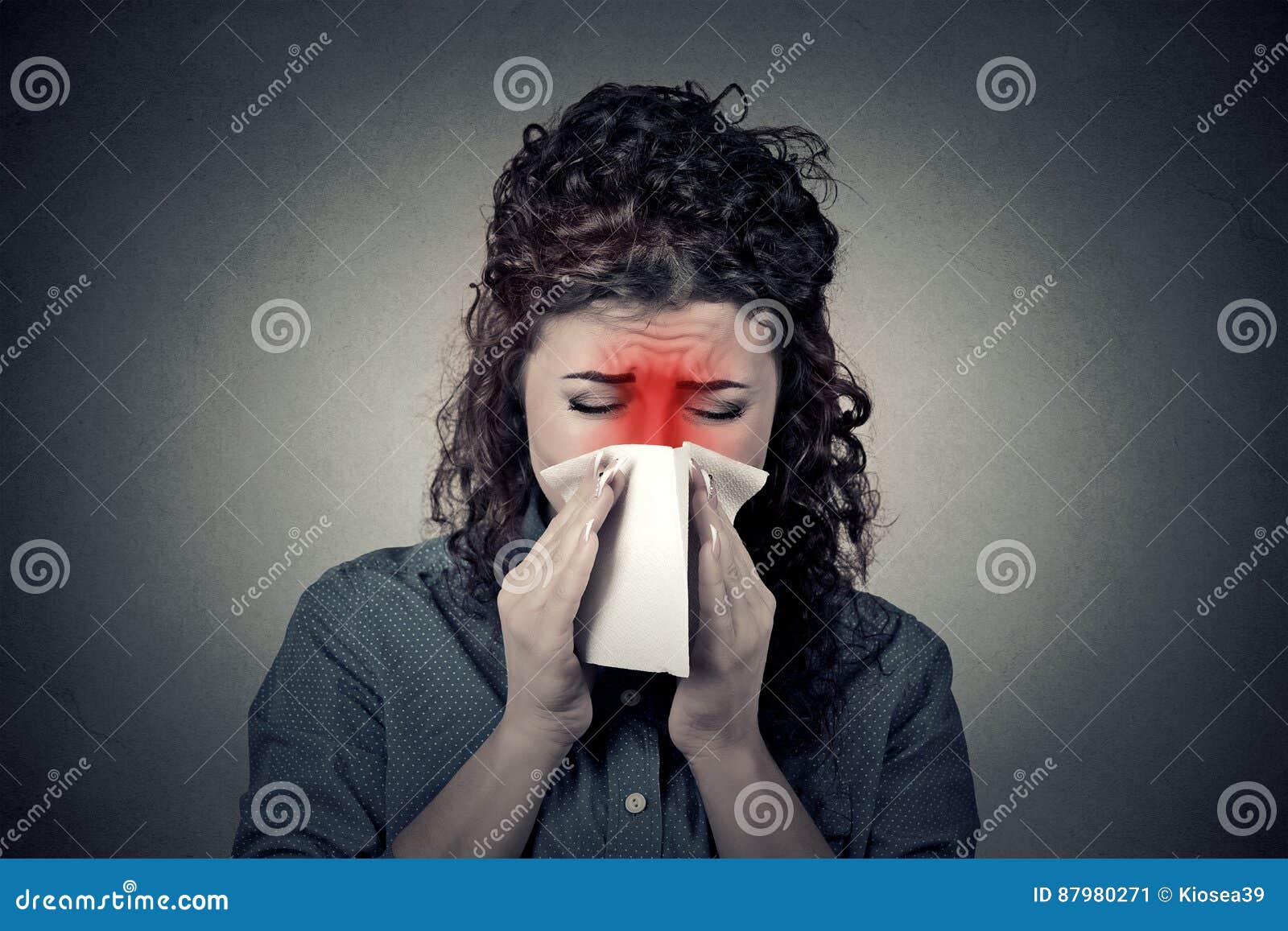 closeup portrait woman sneezing in a tissue blowing her runny no