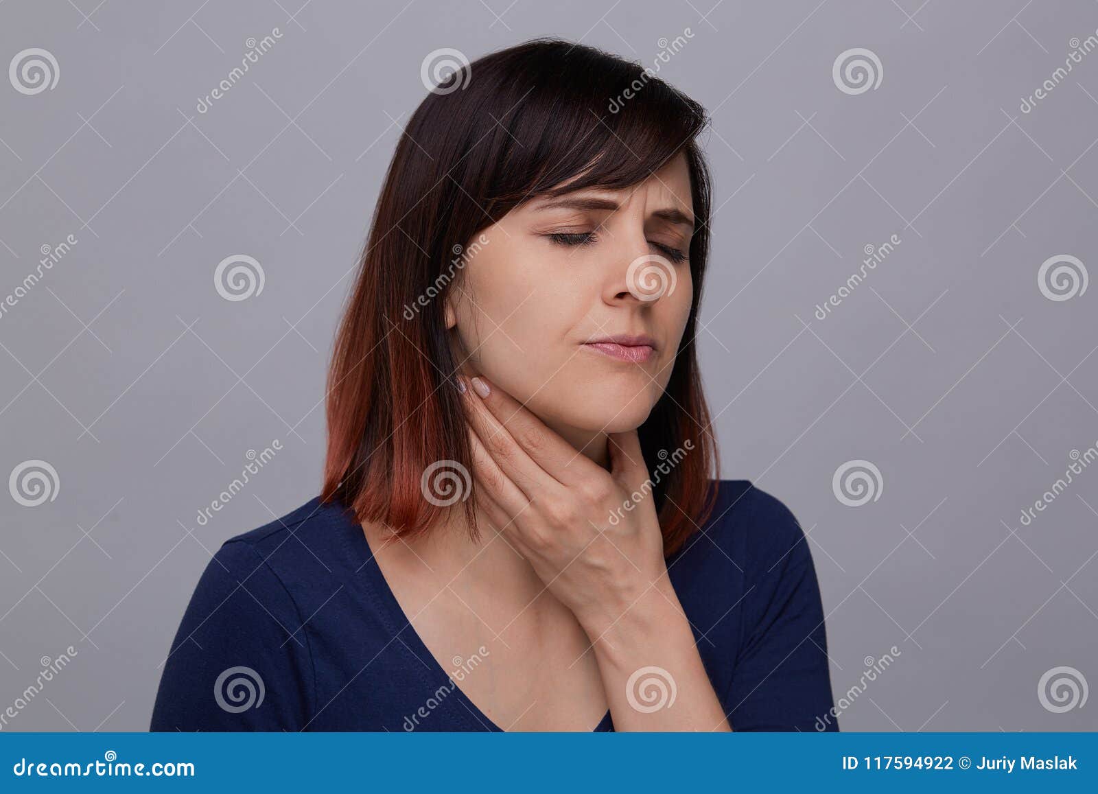 Young Woman Suffering From Strong Headache Holding Fing