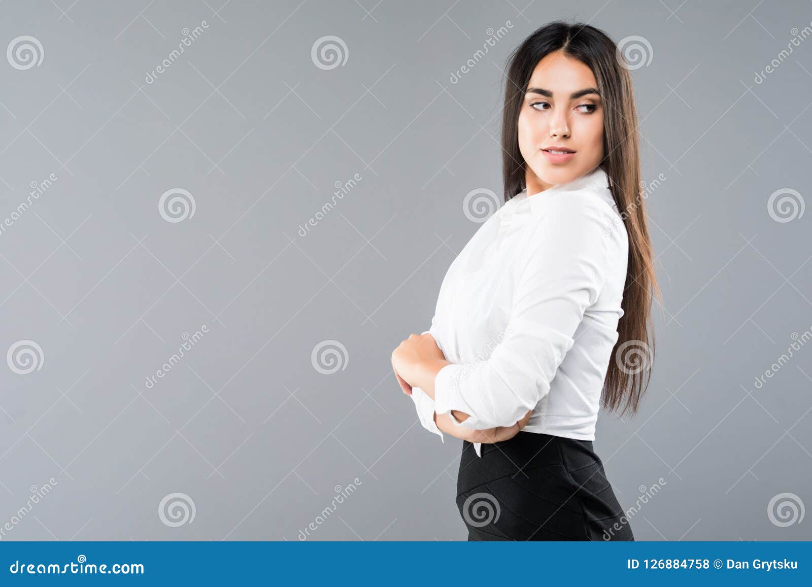 closeup profile of confident business woman looking forward  on gray background