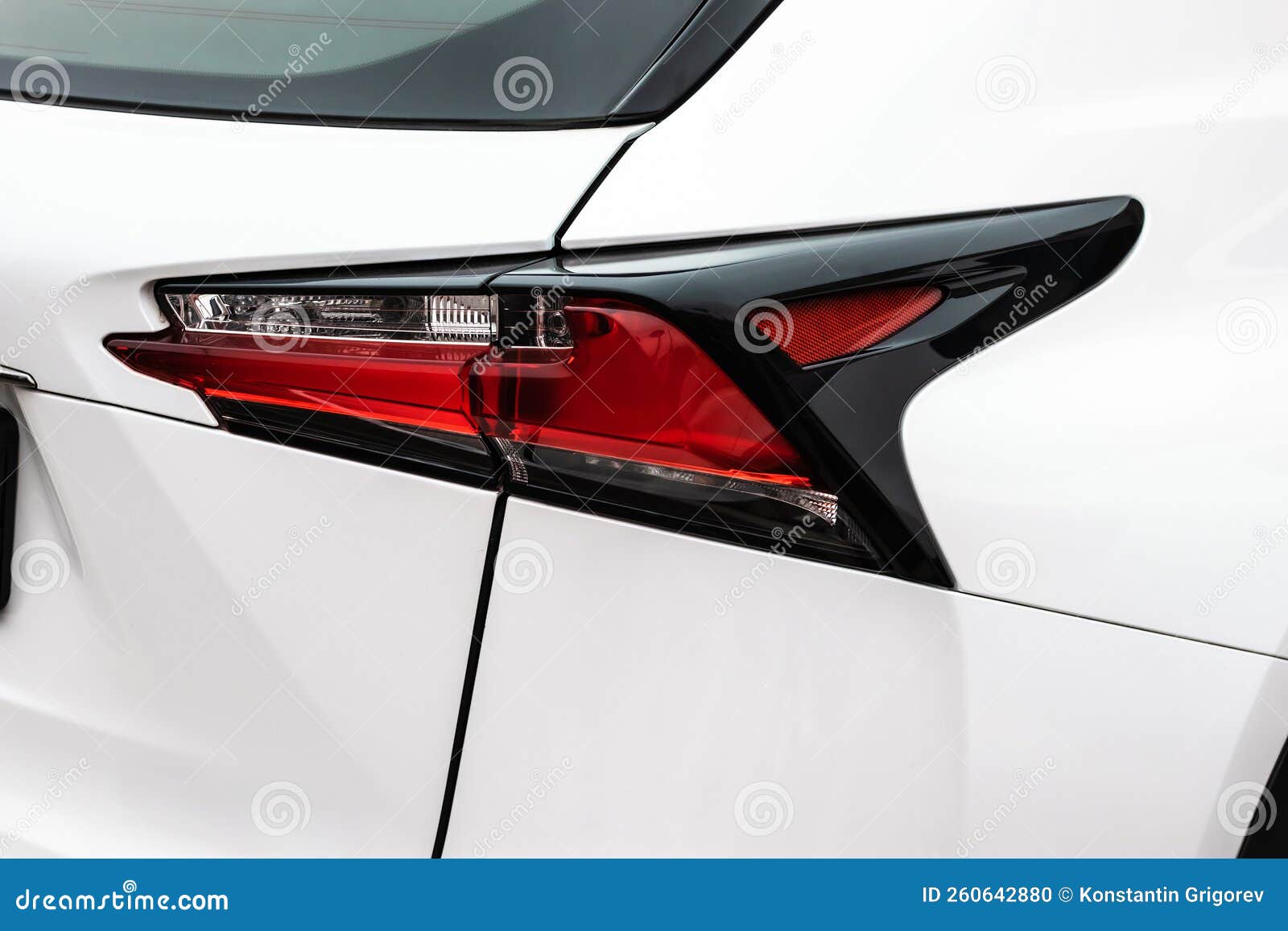 Closeup of Rear Red Taillight on White Suv. Back Lights of Modern Car