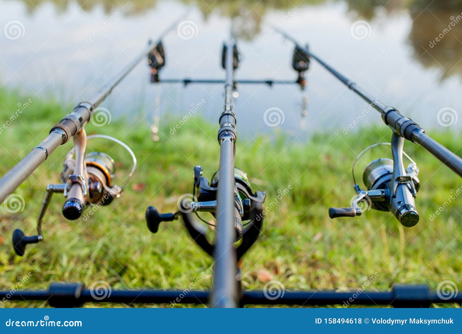 Closeup of a Reel Fishing Rod on a Prop and Water Background Stock Photo -  Image of line, guide: 158494618
