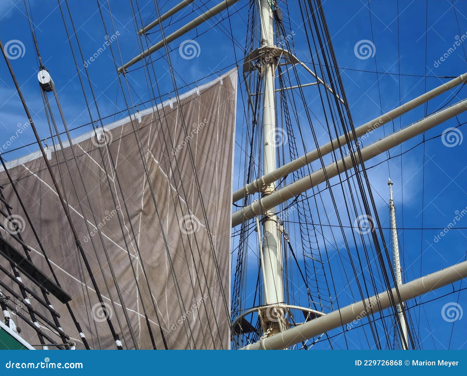 Closeup of Sails and Ropes of a Sailing Ship with Blue Sky Stock Photo
