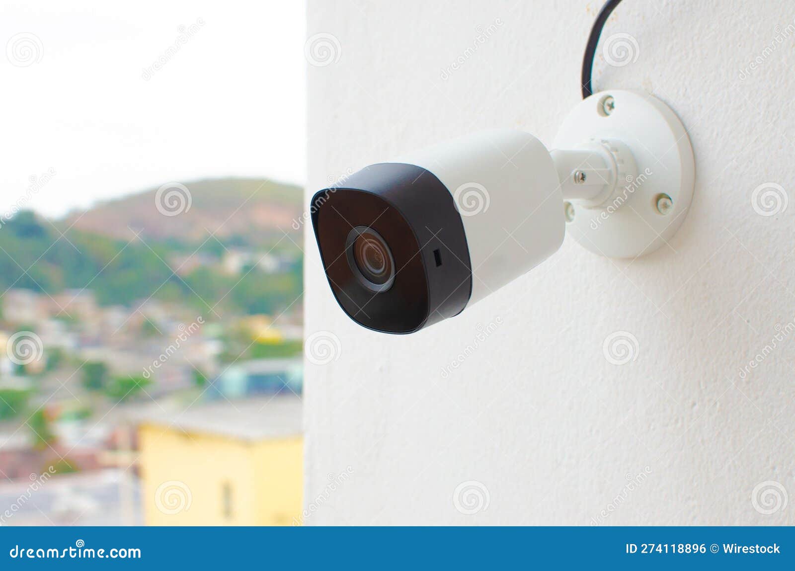 Closeup of a Security Camera Mounted on the Wall of a Building Stock