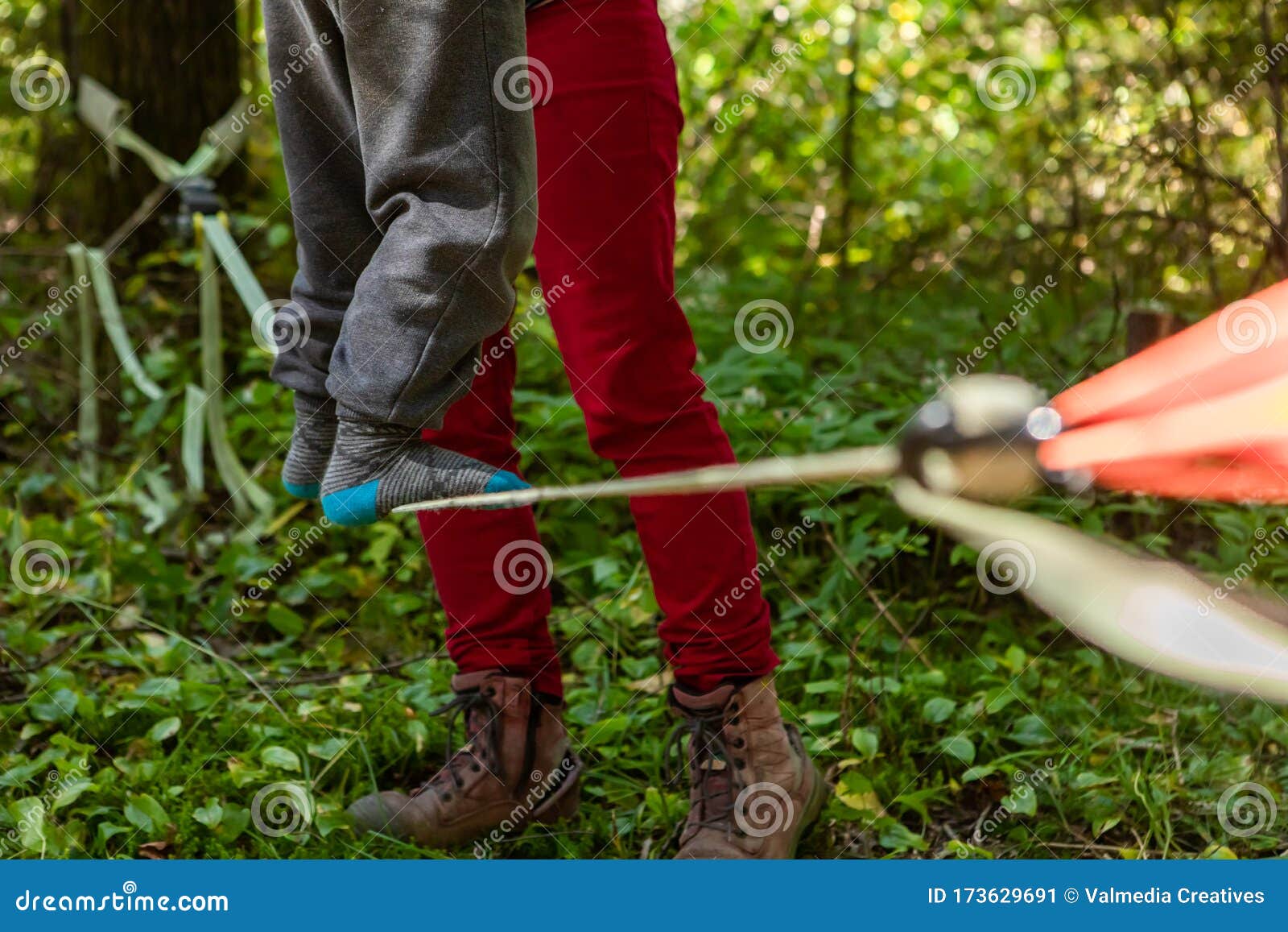 child practices slacklining in nature