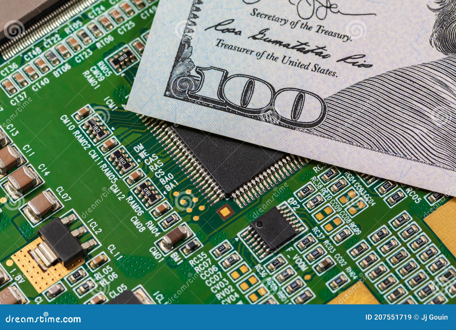 closeup of semiconductor circuit board and 100 dollar bill