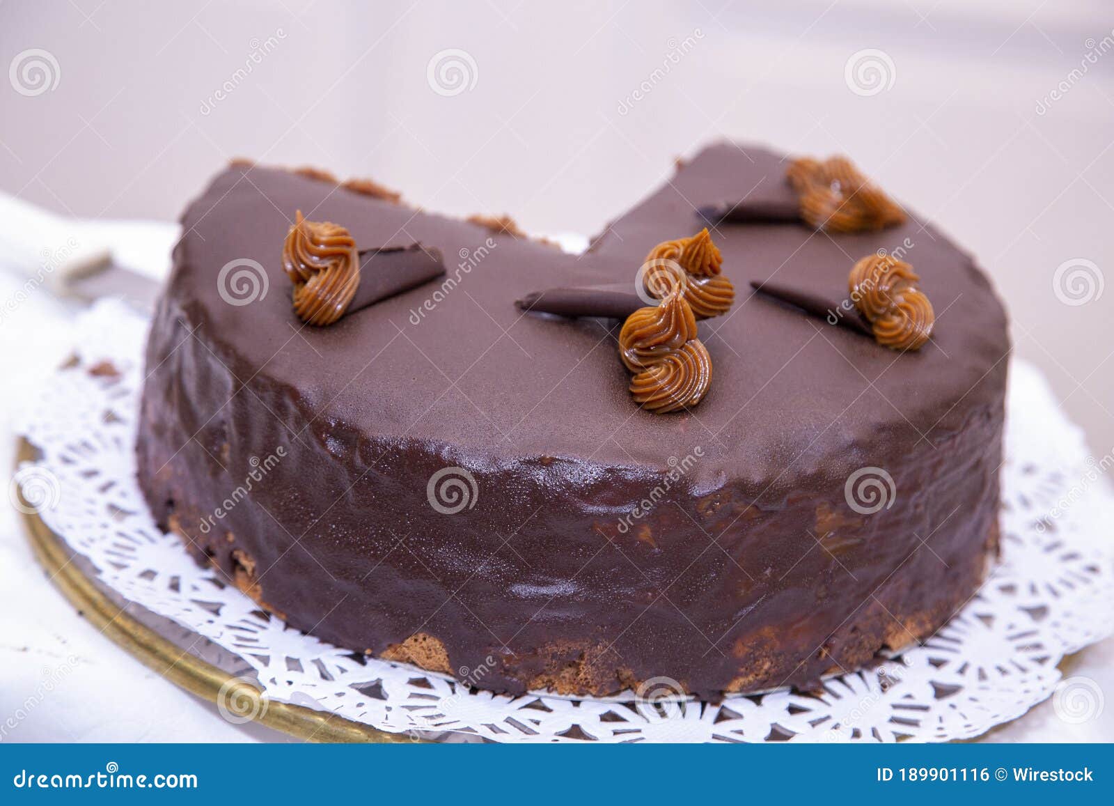 Closeup Shot of a Chocolate Cake with a Quarter Cut Stock Photo Image