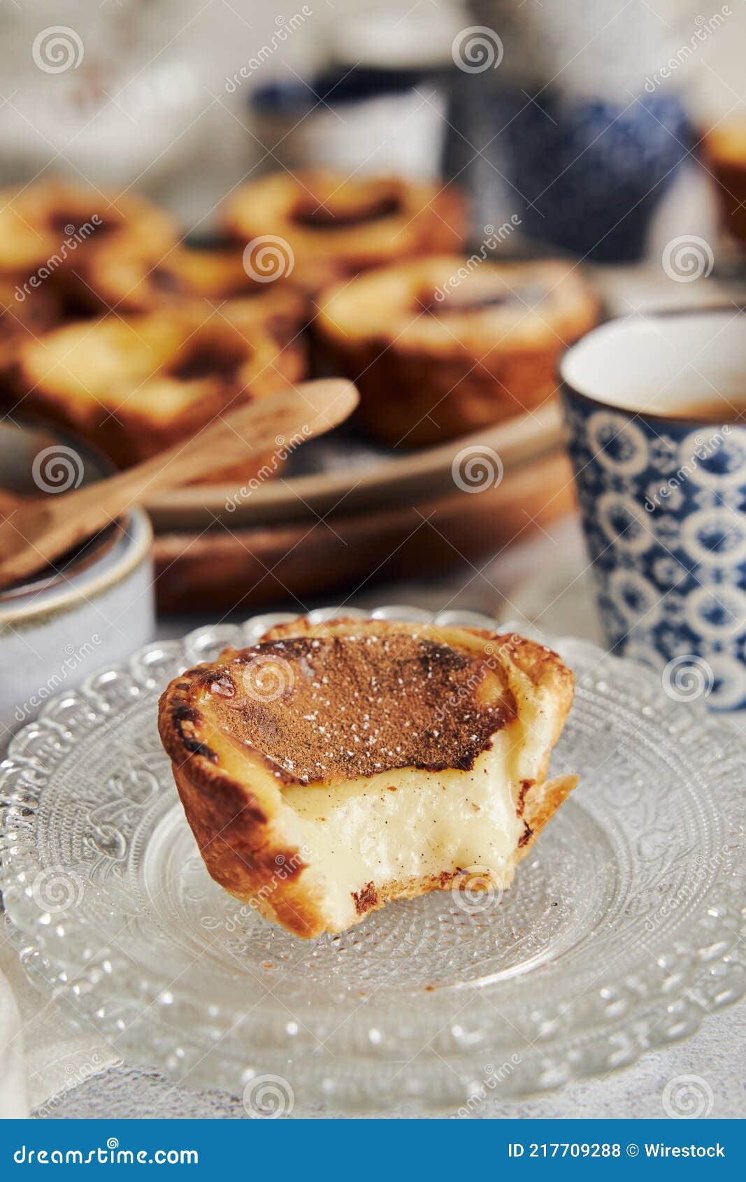 closeup shot of delicious pastel de nata vanilla pastries with espresso on a white table
