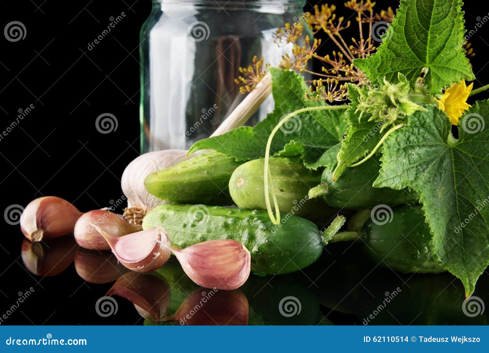 closeup shot jar with gherkins preparate for pickling on black