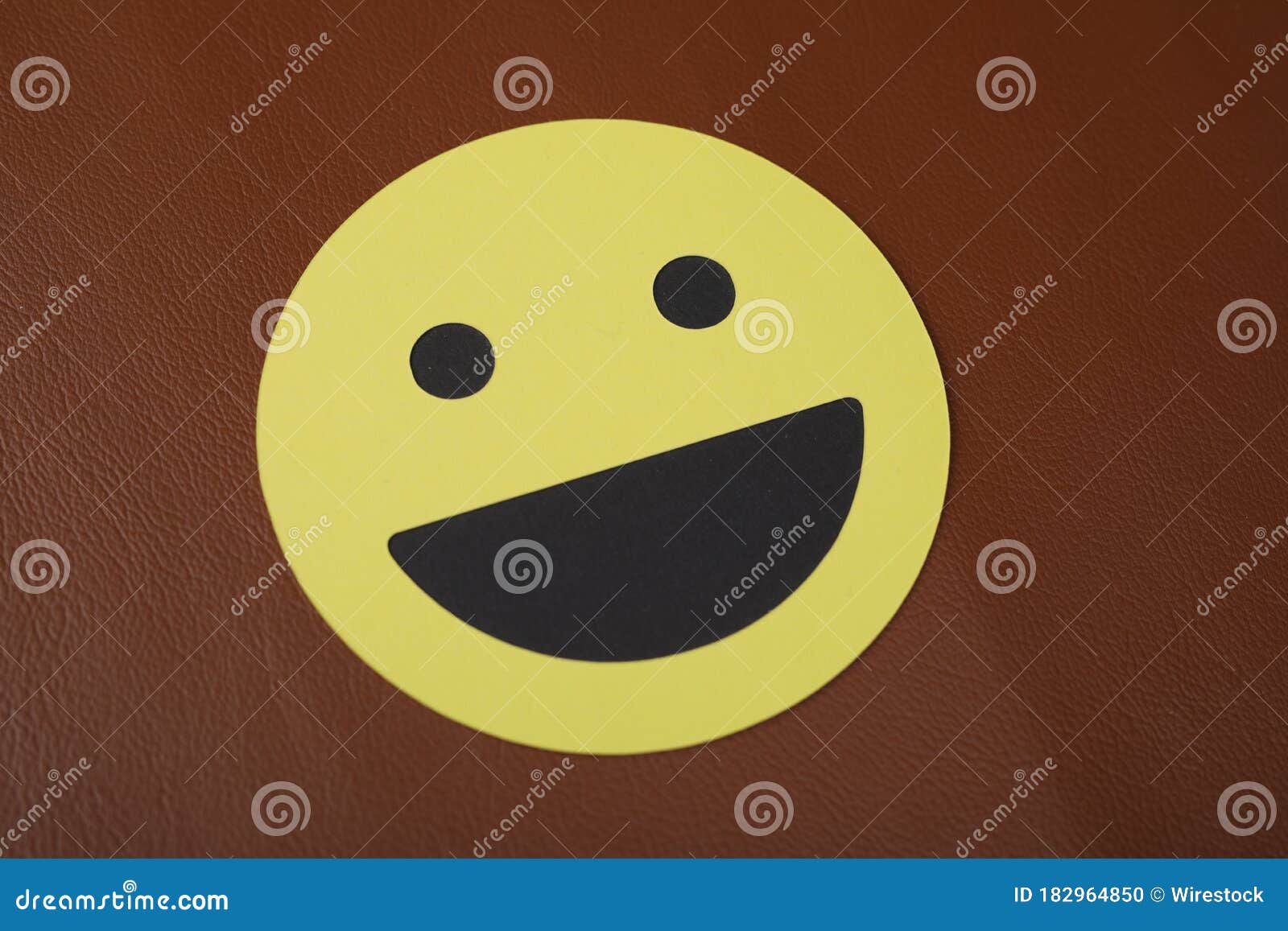 Closeup Shot of a Laughing Smiley Face Sign on a Brown Background ...