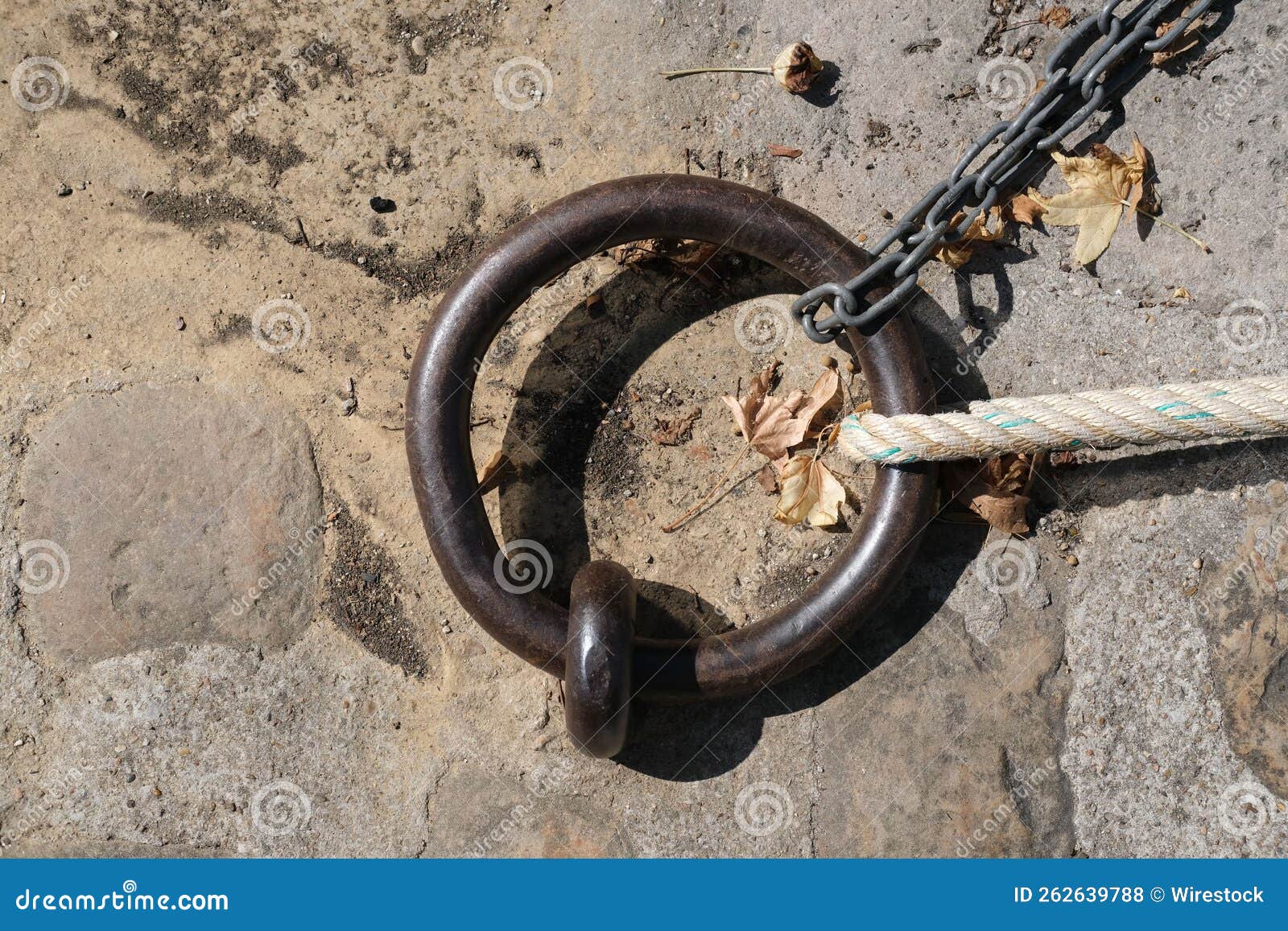 Closeup Shot of a Loop Ring Placed on the Ground with Chains and Ropes