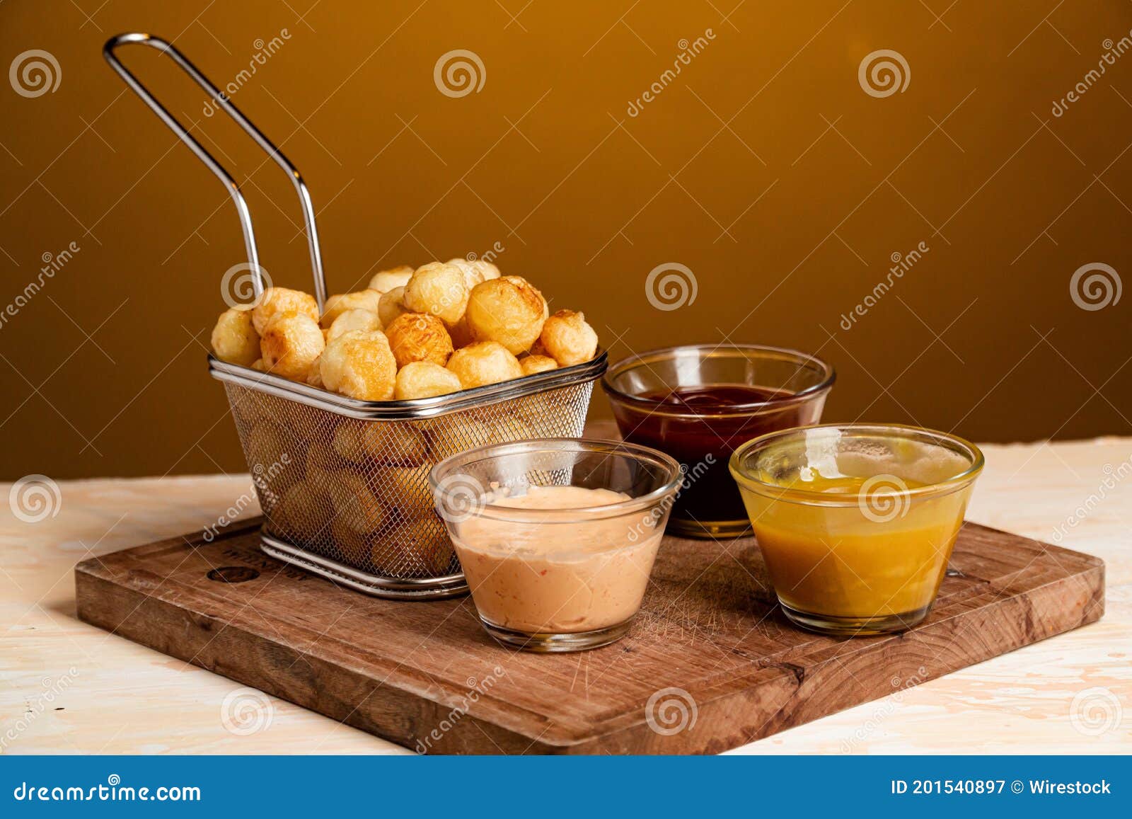 closeup shot of noisette potatoes with various sauces shot of