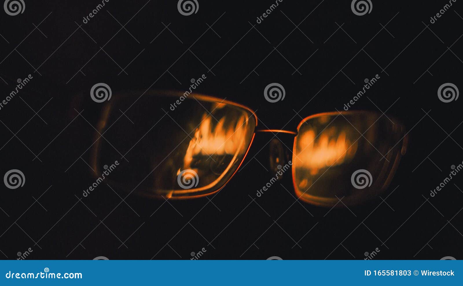 Closeup Shot of a Pair of Glasses with the Reflection of Fire Flames on
