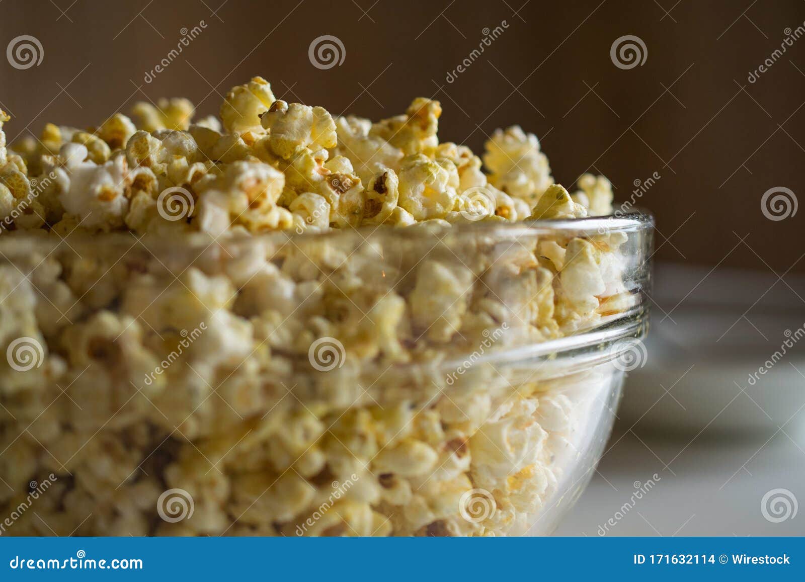 Closeup Shot Of Popcorn In A Glass Bowl With A Blurred Background Stock