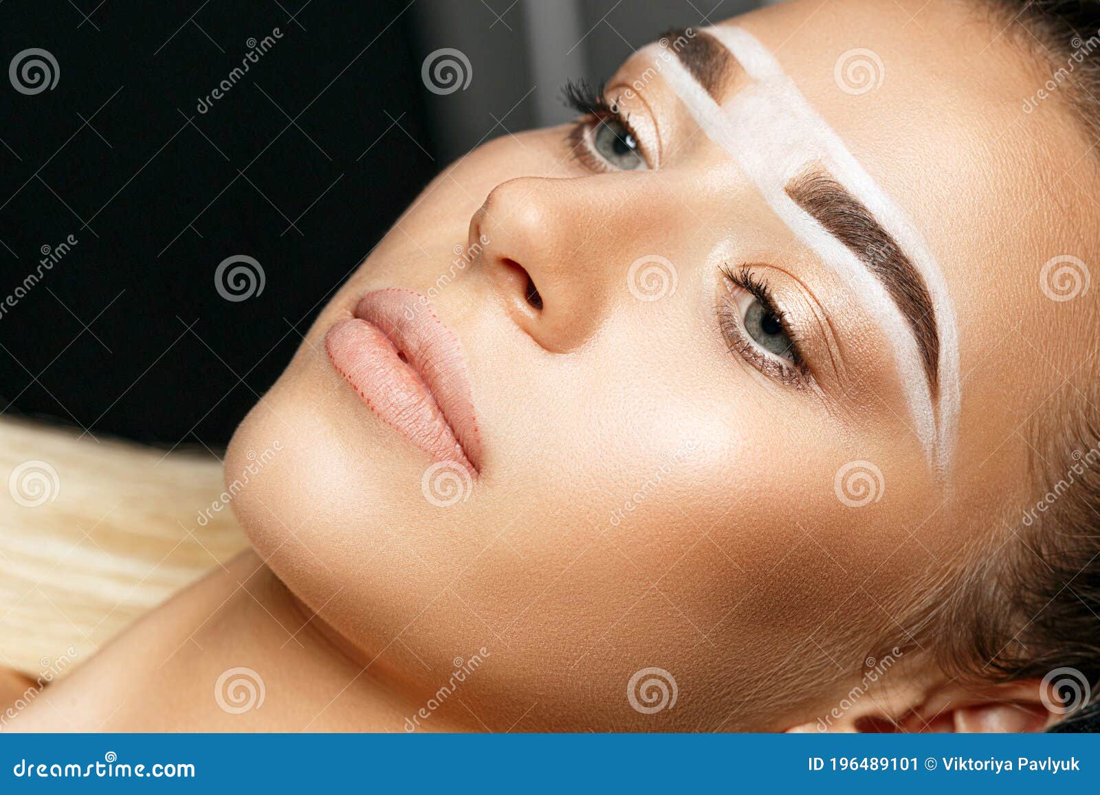 closeup shot of a pretty woman`s face with brow paste