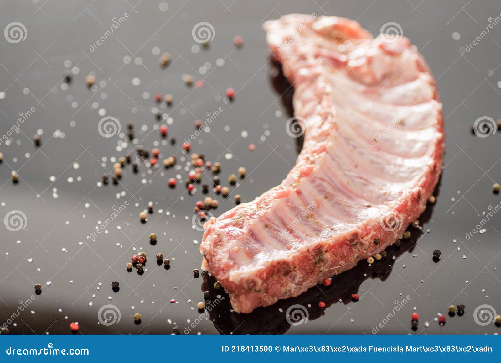 a closeup shot of raw pork ribs being cooked with seasonings
