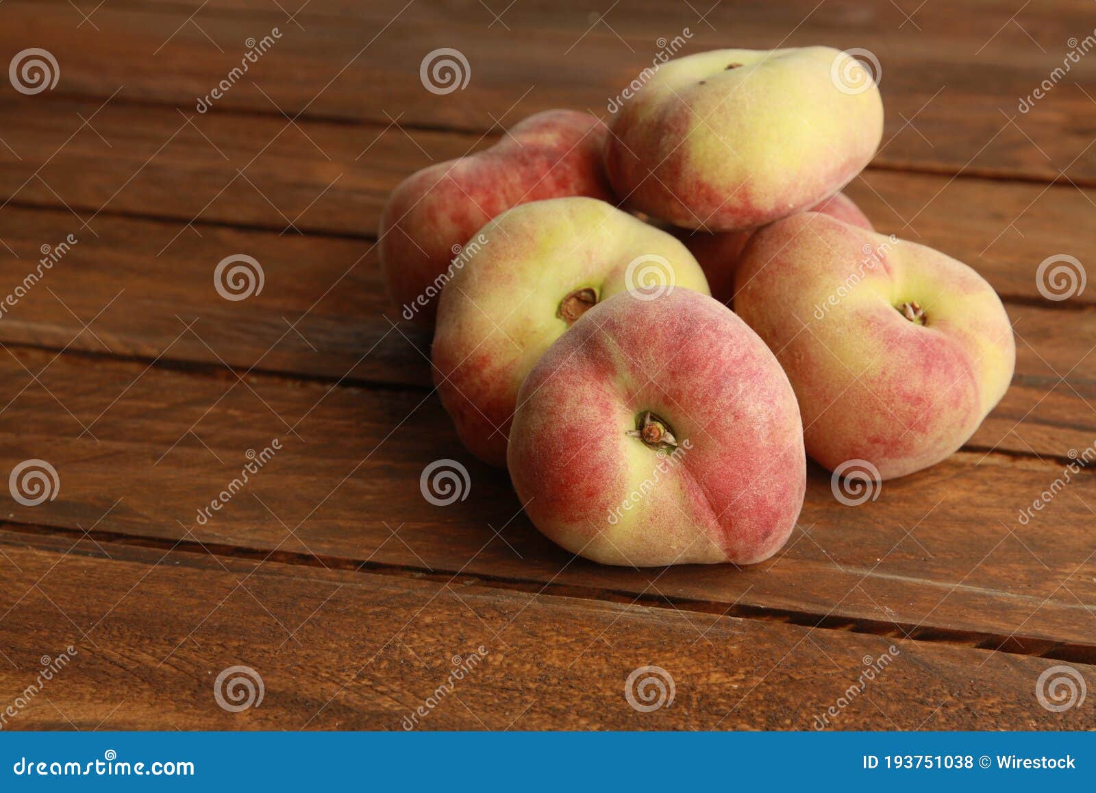 closeup shot of ripe paraguayan peach on a wooden surface