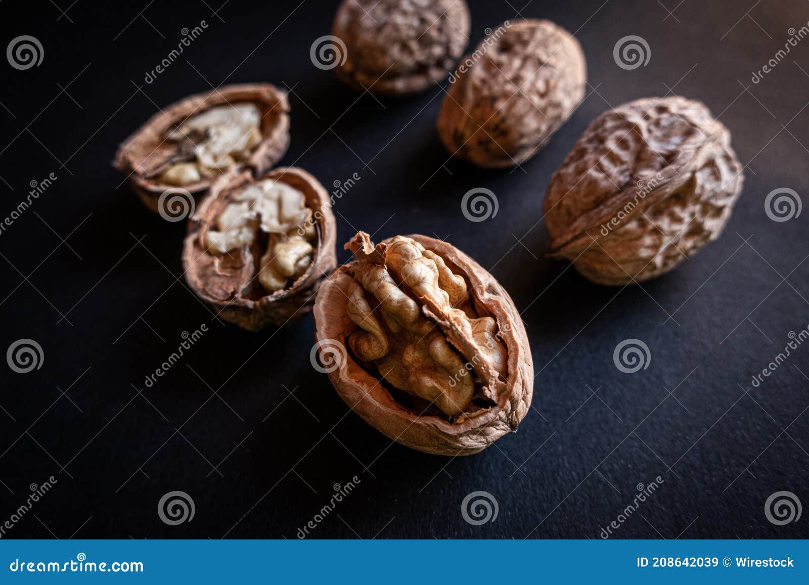 Closeup Shot of Several Full and Half Walnuts Placed in Row on an