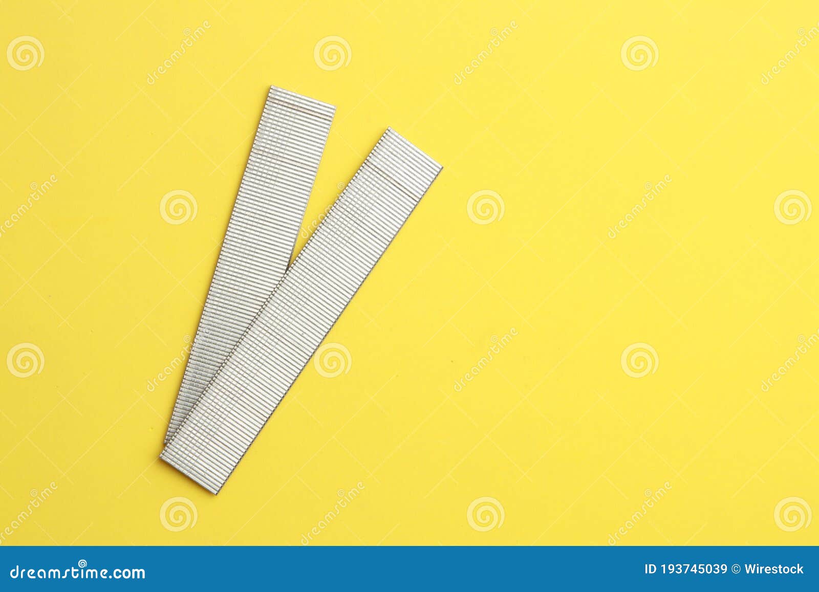 Closeup Shot of Staples Isolated on Yellow Background Stock Image