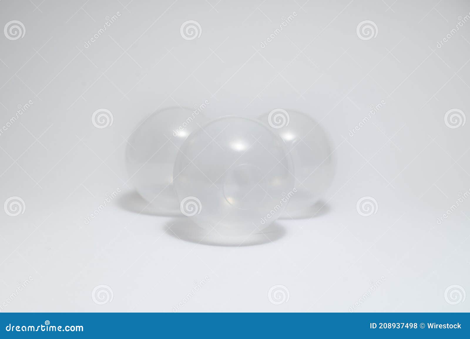 Closeup Shot of Three White Plastic Balls on a Gray Background Stock