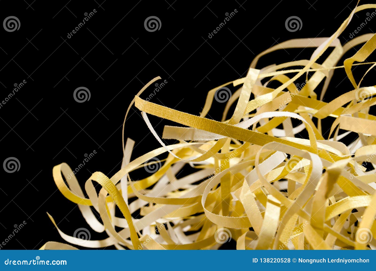 closeup shredded paper texture and reuse yellow color,colorful paper scrap of document on black background. selective focus image
