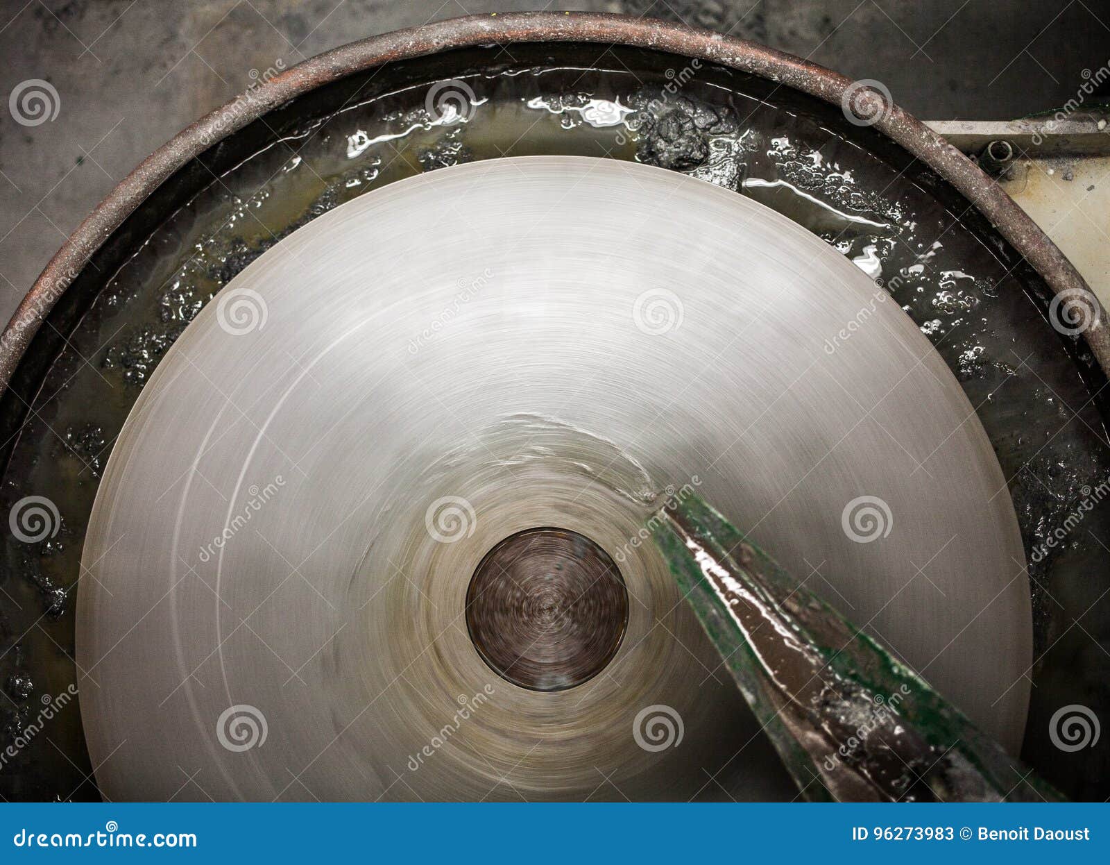 closeup of silica sanding table spinning and water drooping