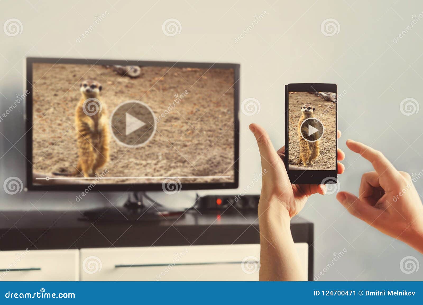 closeup of a smart phone is connected to a smart tv.