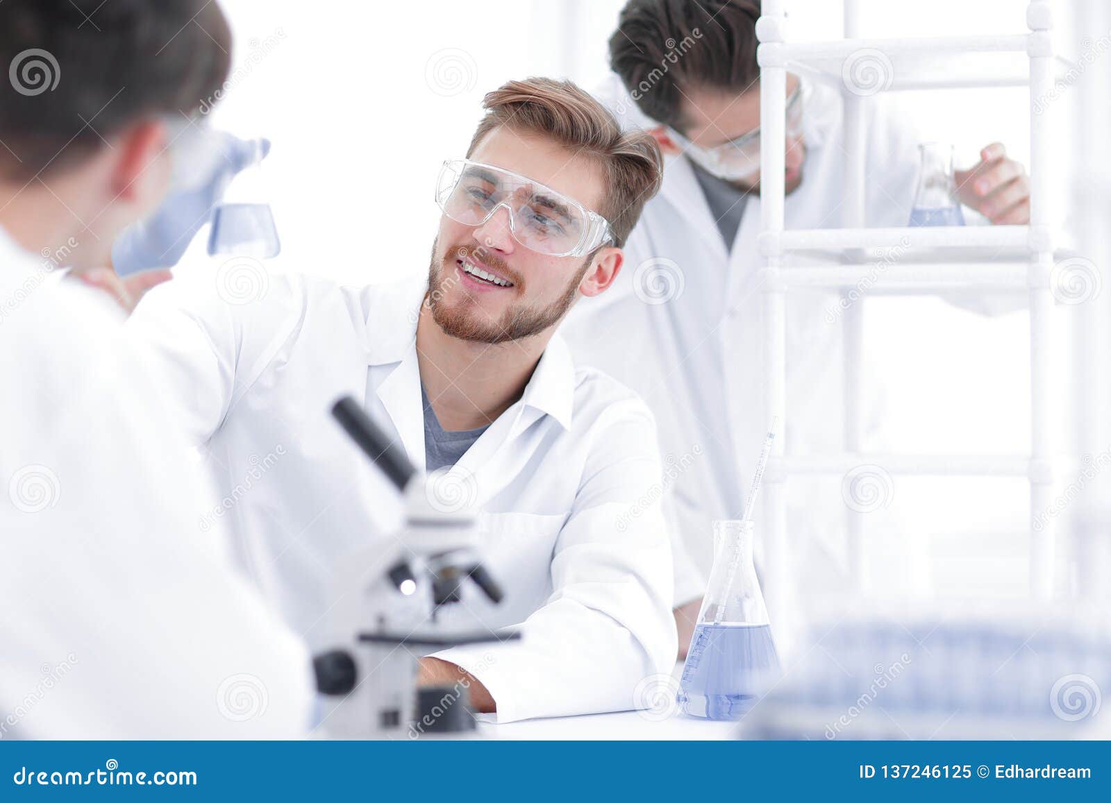 Team Of Biologists Men Examining Engineered Foods Plants