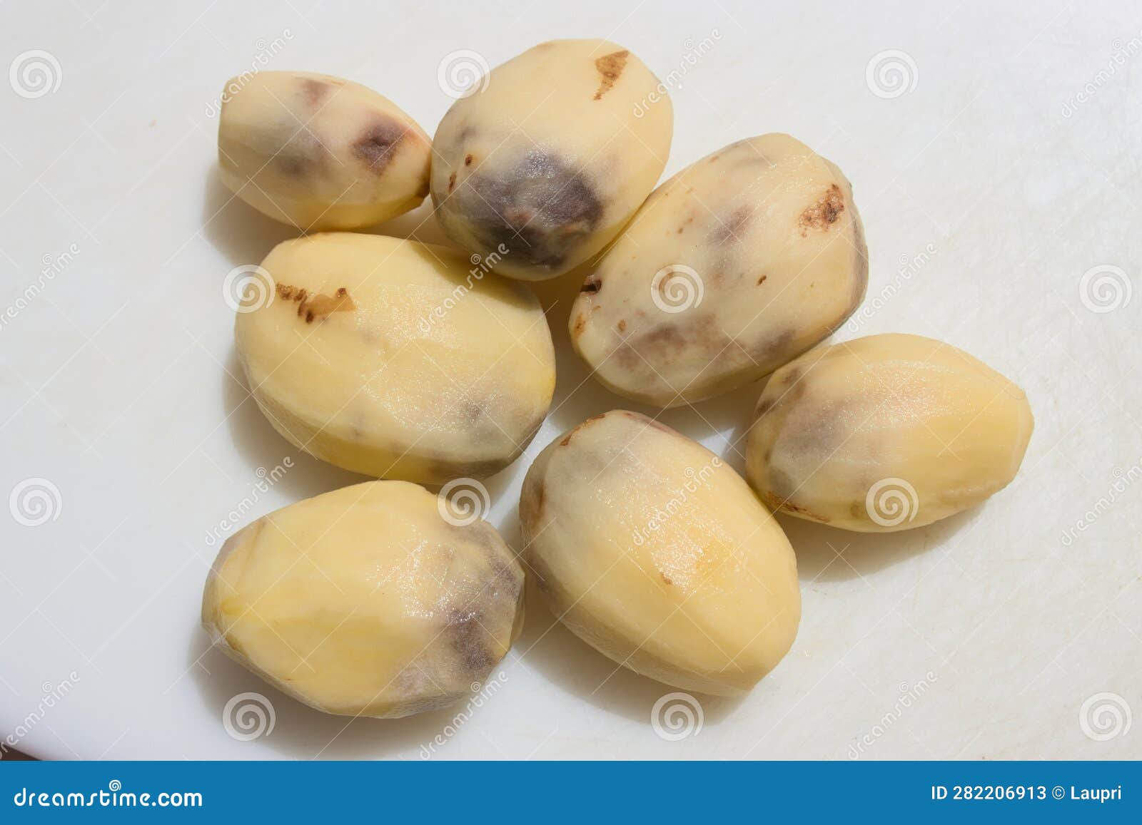 Closeup of Some Peeled Potatoes that Have Black Spots Inside Stock