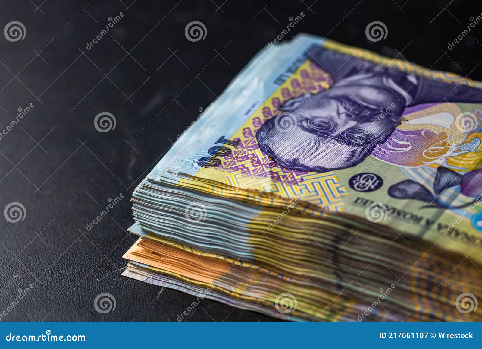 closeup of a stack of 100 lei banknotes - world money, inflation and economy concept