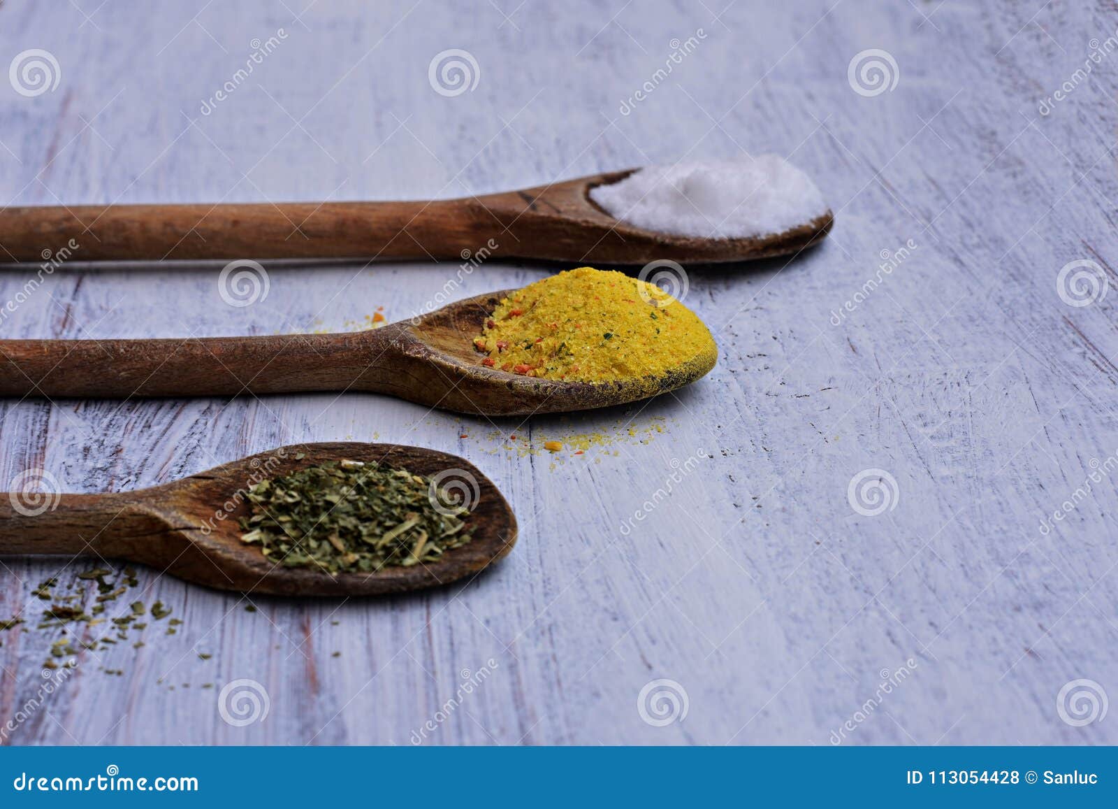 Assortment Of Colorful Spices In The Wooden Spoons On The White