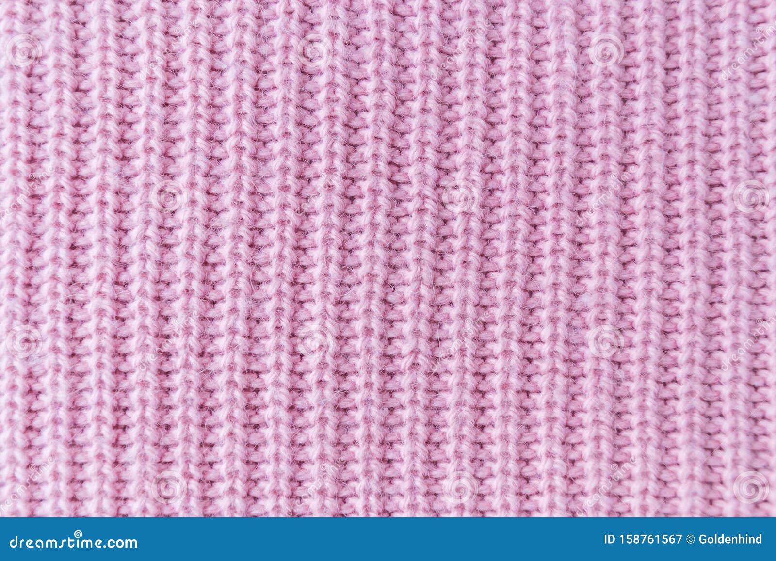 the closeup texture of pink cashmere sweater background. macro shot of knitted fabric from lana wool threads