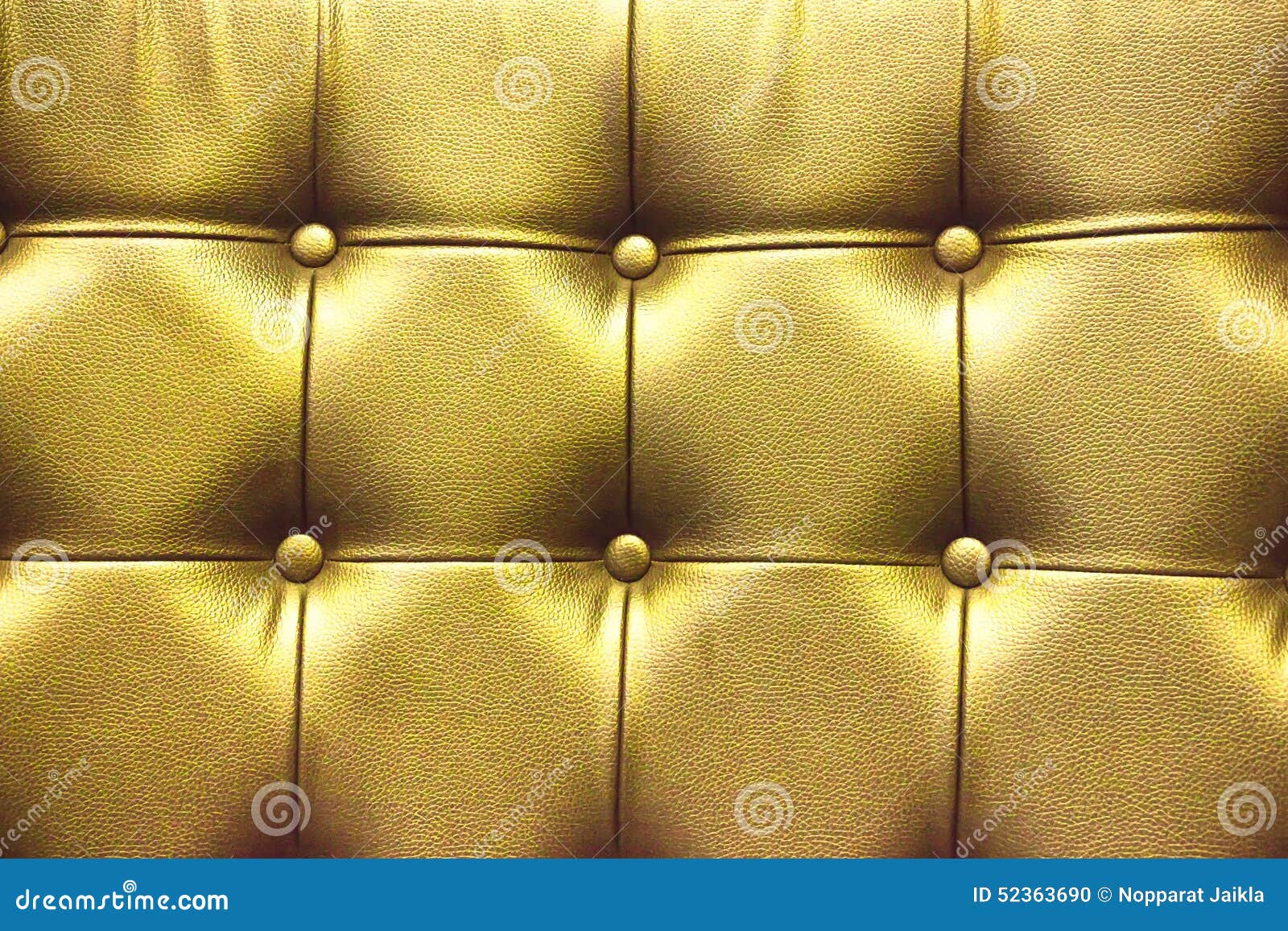 Closeup Texture of Vintage Gold Leather Sofa for Background Stock Photo