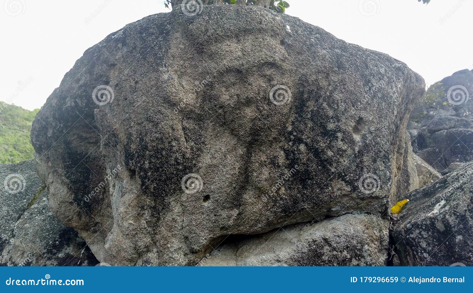 closeup to an ancient petroglyph of human face at colombian san agustin archaeological park.