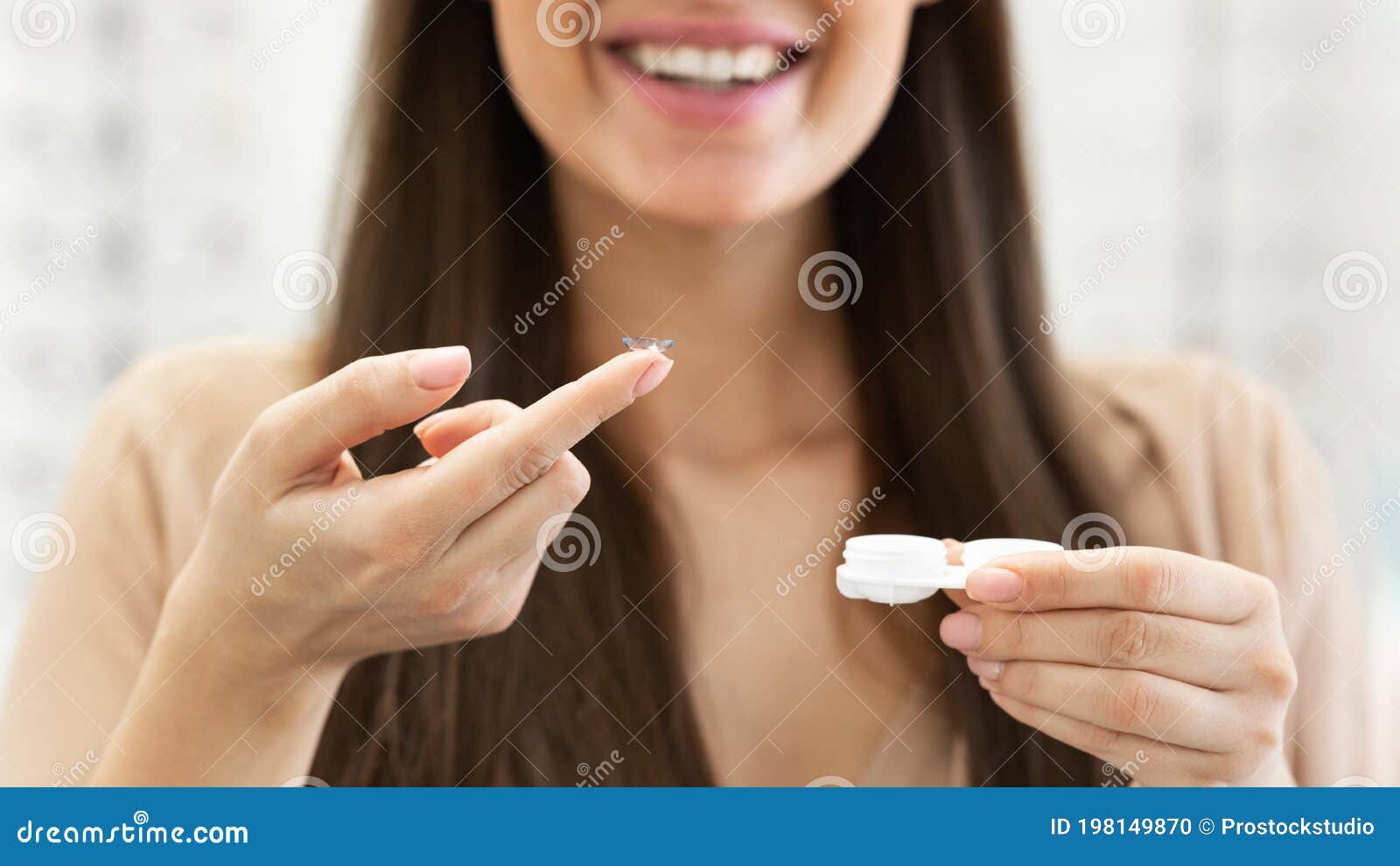 closeup of unrecognizable lady holding contact eye lenses