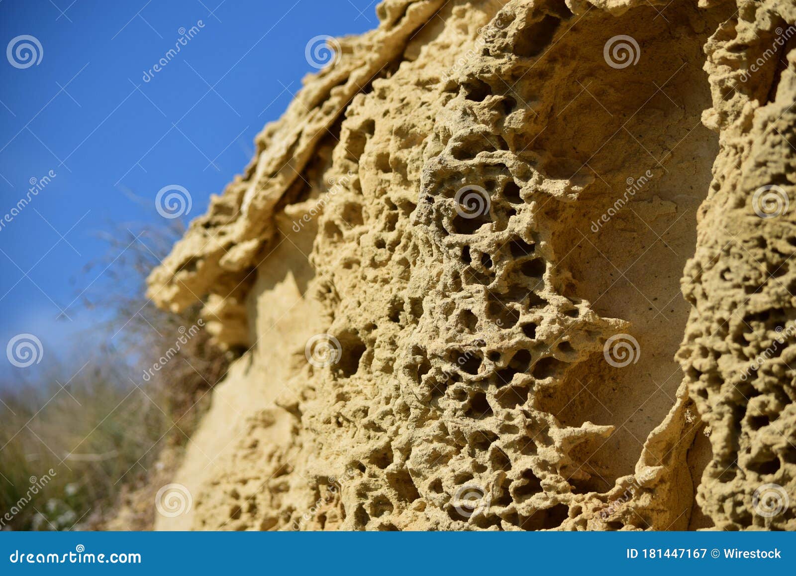 closeup of the weathering of the globigerina limestone under the sunlight and a blue sky in malta