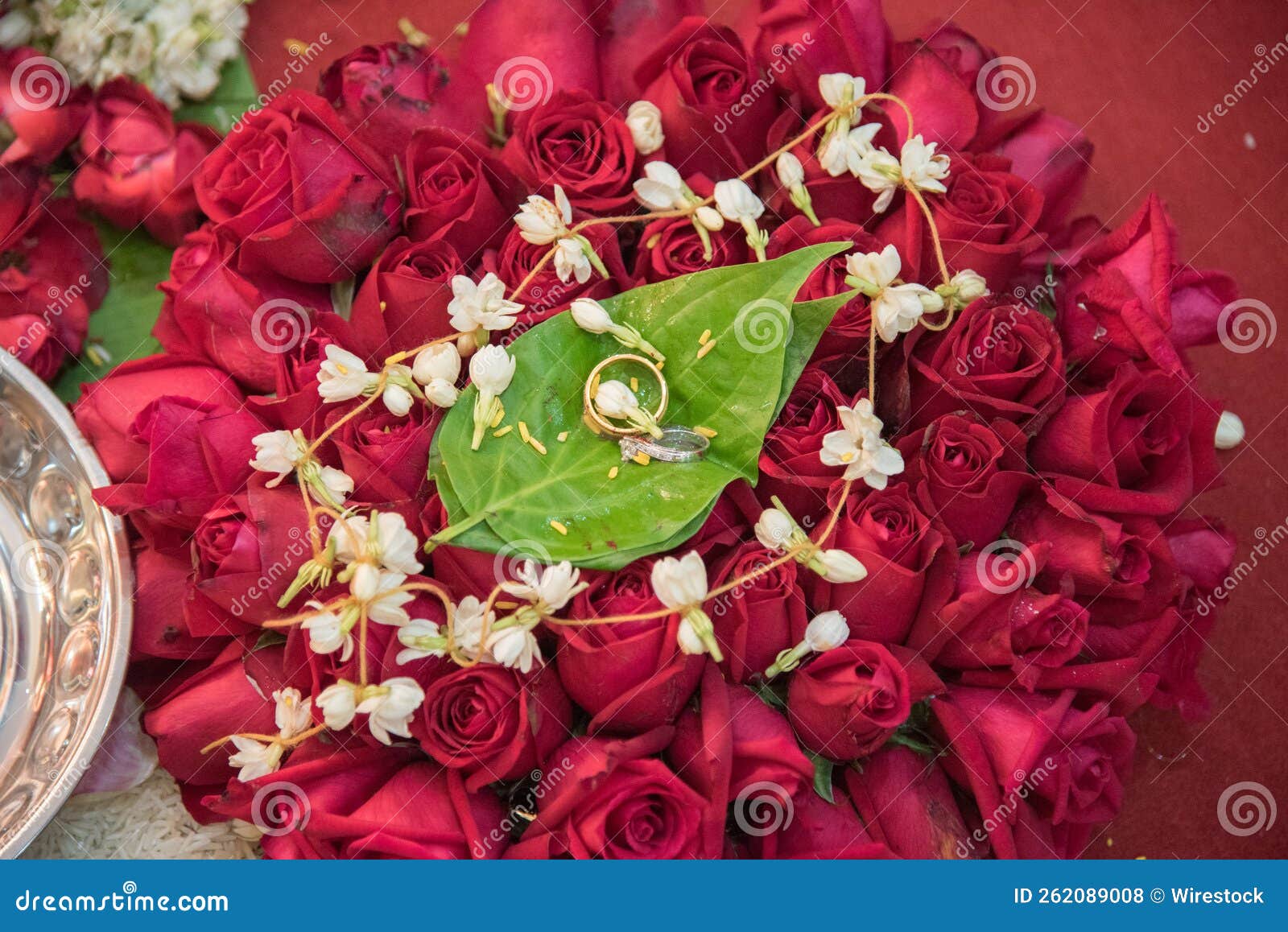 Closeup of Wedding Rings on Beautiful Flowers in a Wedding Event Stock