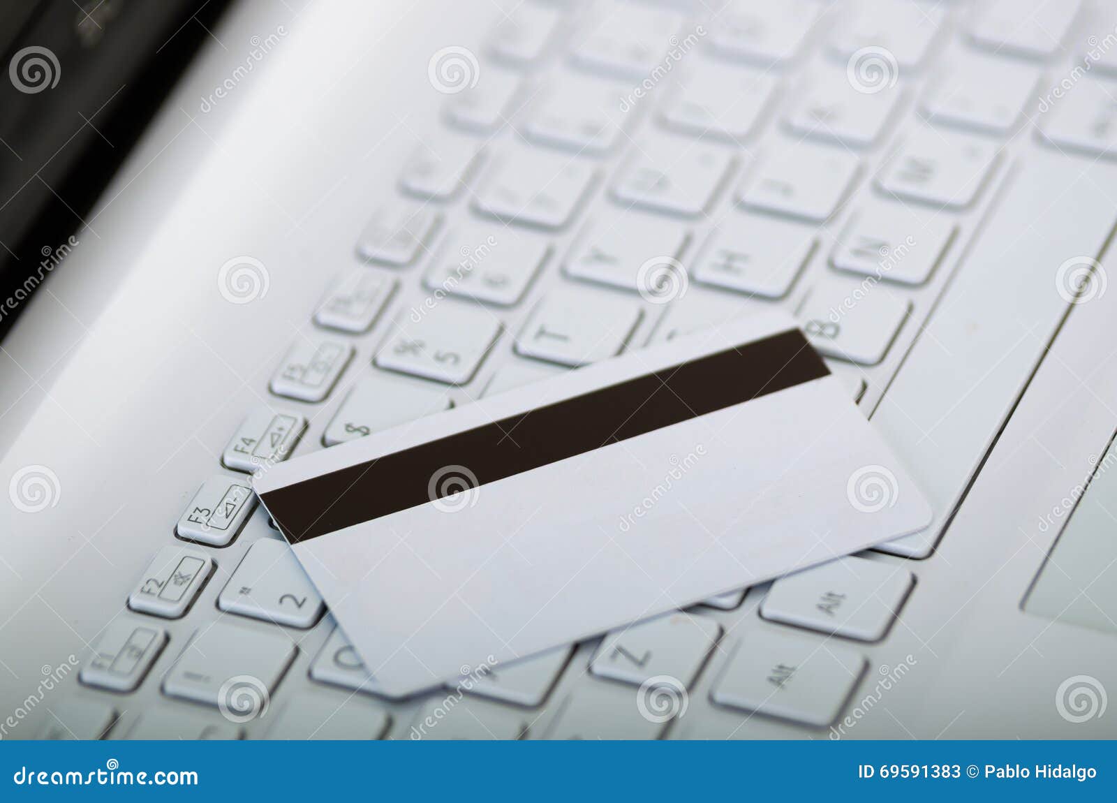 Closeup White Electronic Swipe Card with Stripe Visible Lying