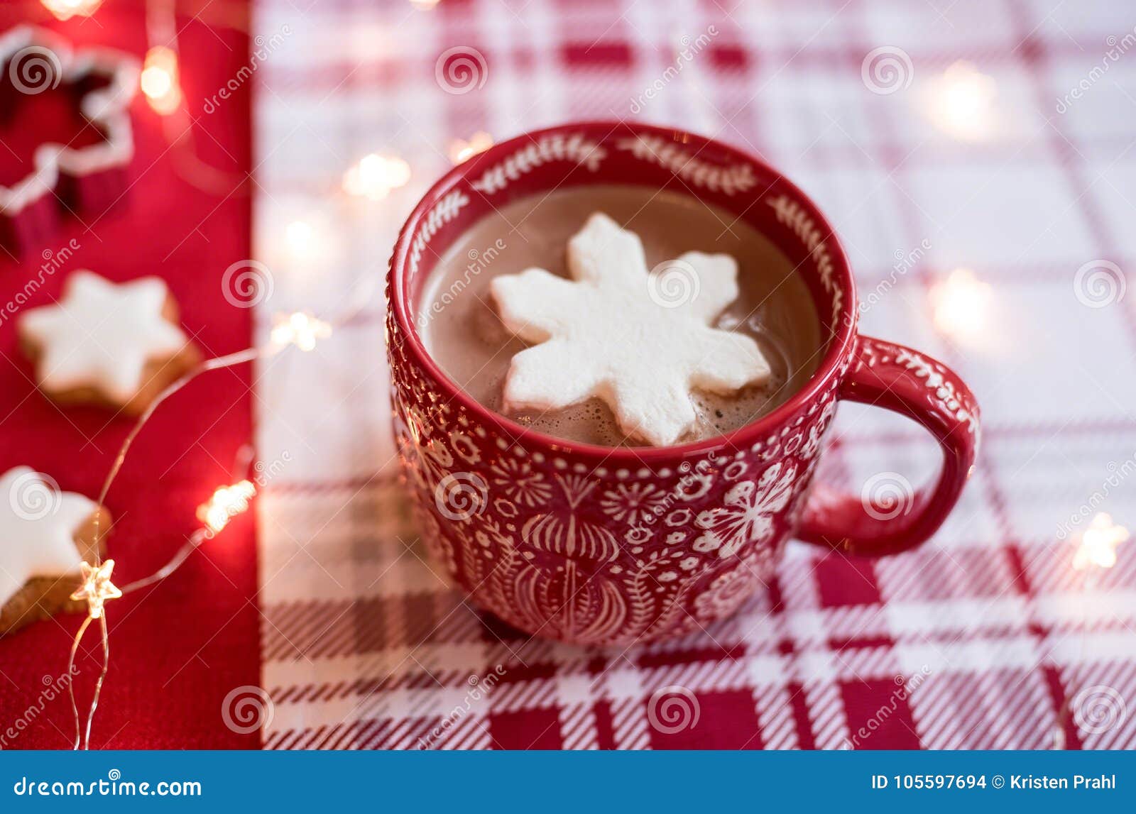 Red thermos next cup with hot chocolate with marshmallows on table with  snow outside Stock Photo - Alamy