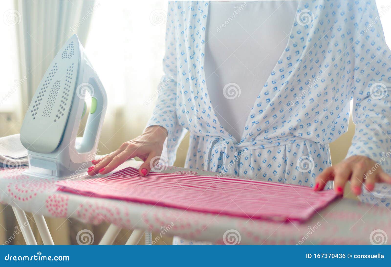 Closeup of Woman Ironing Clothes on Ironing Board Stock Photo Image