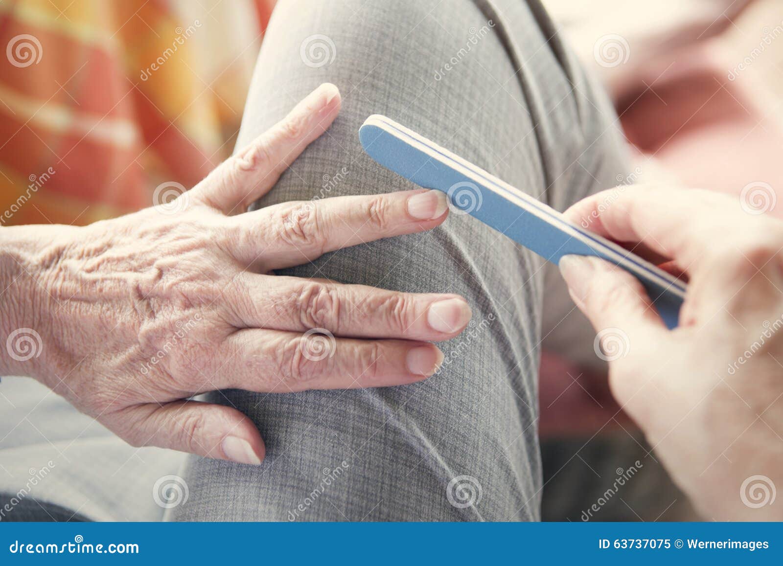 closeup of woman's hand with nailfile