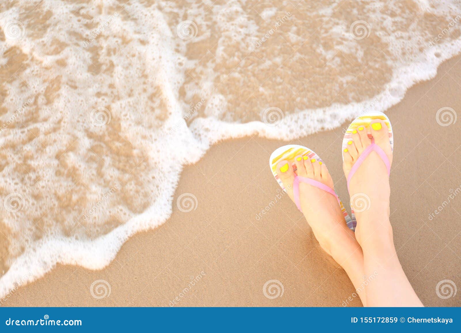 Closeup of Woman Stylish Flip Flops on Sand Near Sea, Space for Text ...