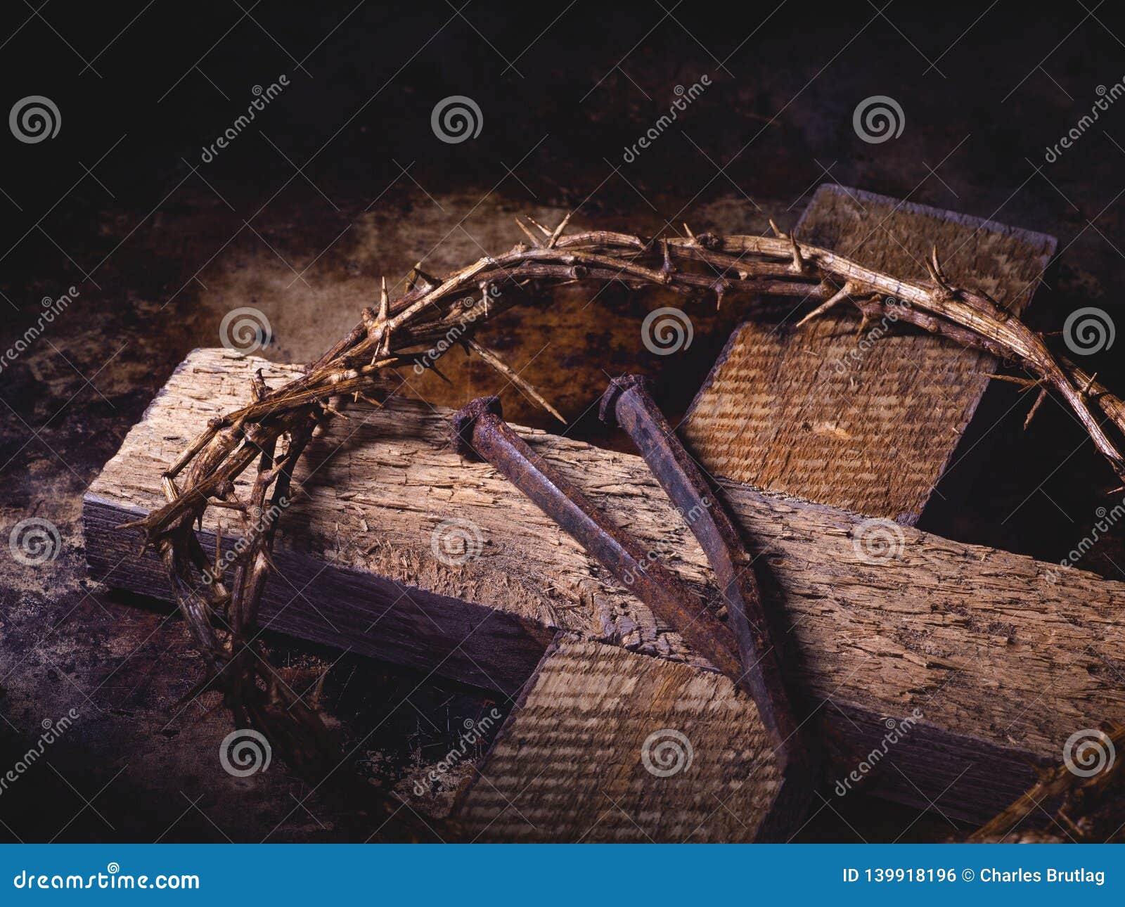 closeup of a wooden cross, crown of thorns and nails