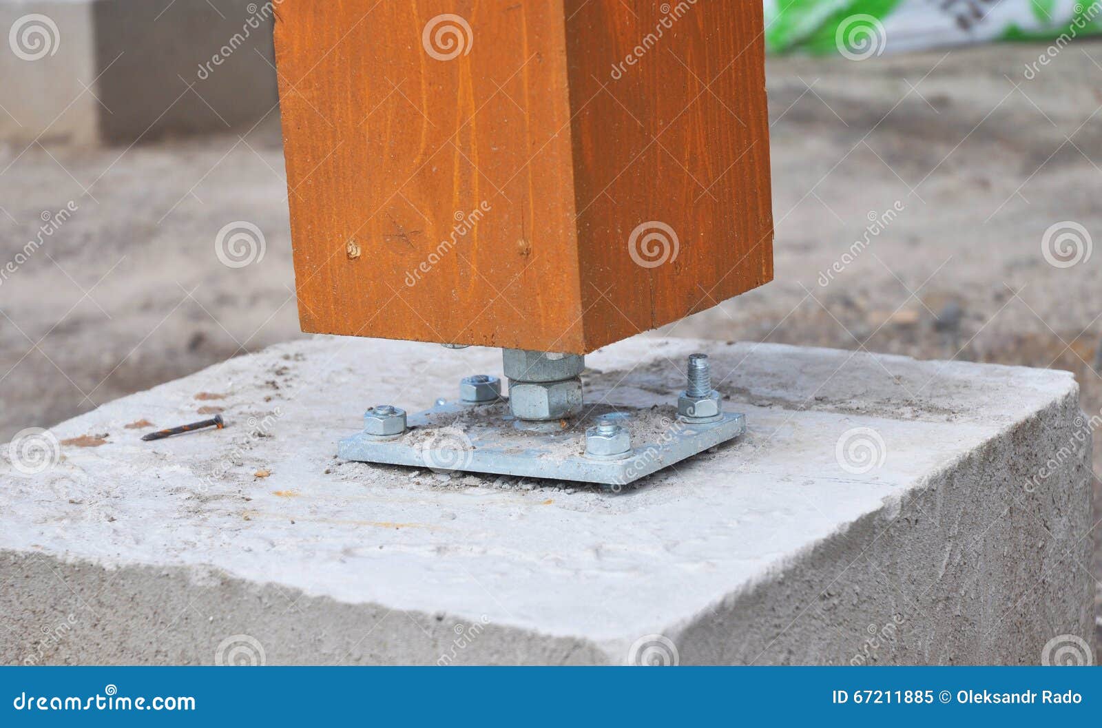 Closeup of Wooden Pillar on the Construction Site with Screw. Stock
