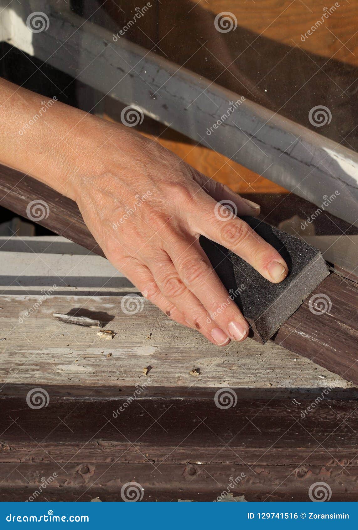 Worker sanding old window stock photo. Image of occupation 129741516