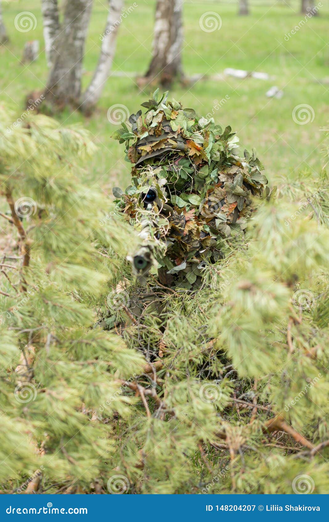 Camouflaged sniper lying in forest and aiming through his scope Stock Photo  by ©Nesterenko_Max 89112398