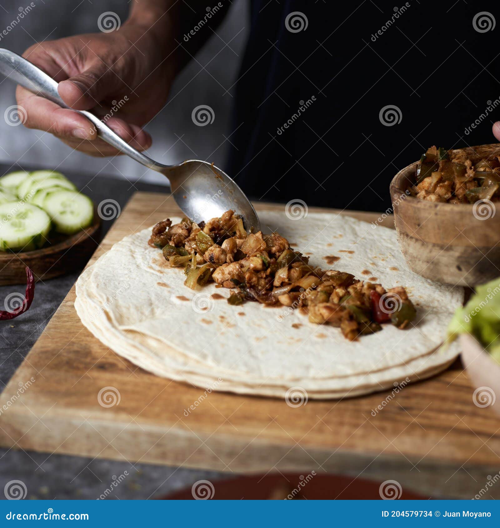 man preparing a durum or a burrito